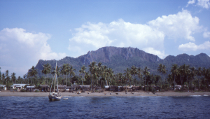 Village on the north coast of Seram with dramatic limestone peaks in the distance.